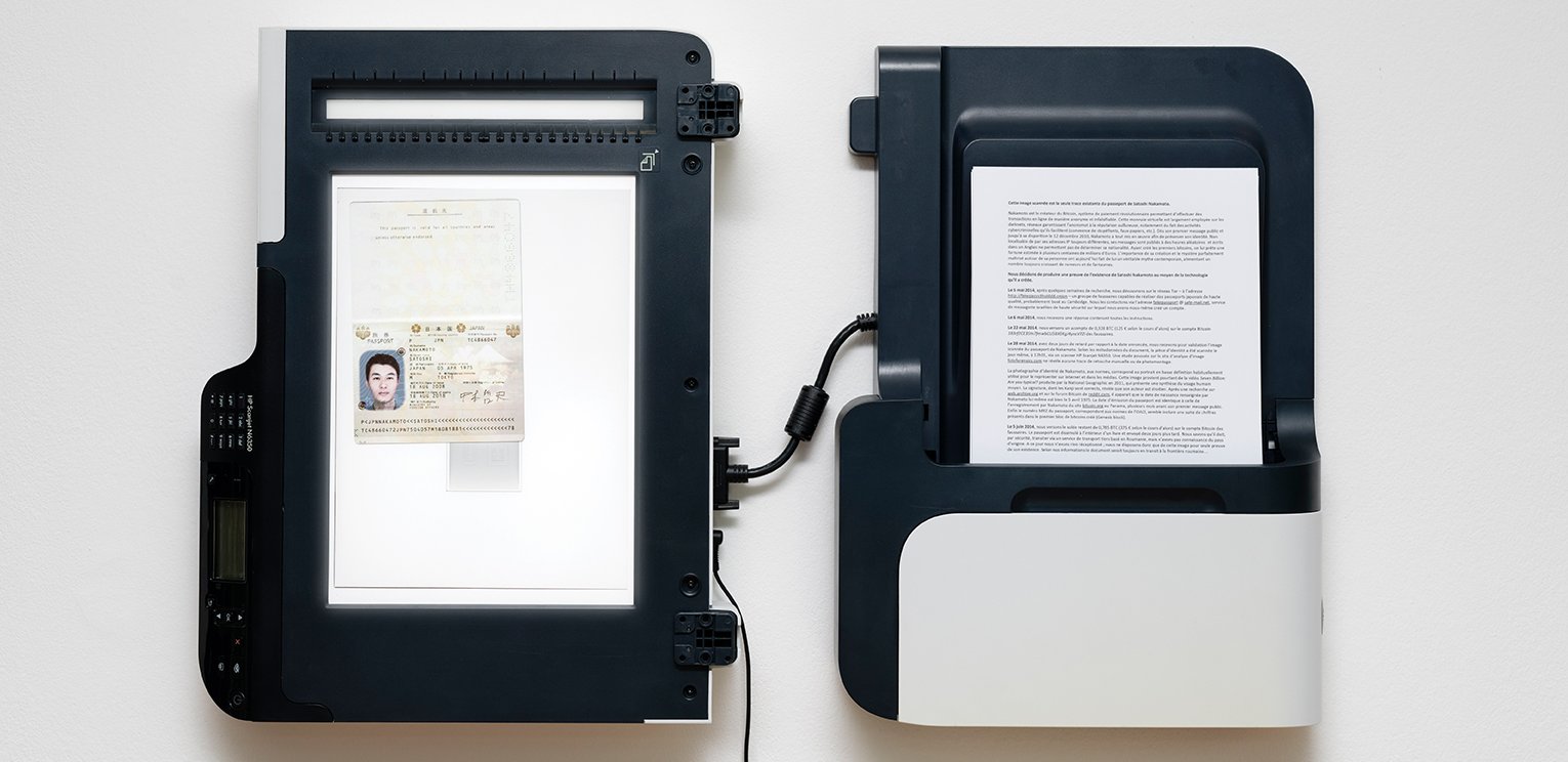 A photo of a deconstructed scanner with a passport photo on the scanning bed and a document with typed text as the input