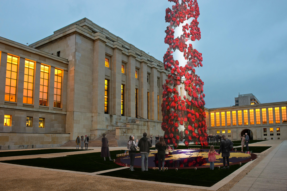 A digital rendering of a column of red flowers rising over a public square