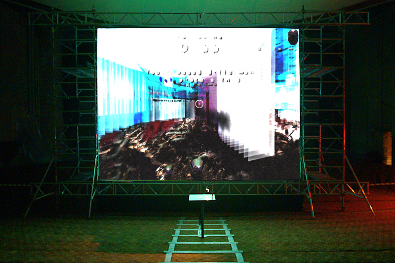 A photo showing an abstract image projected onto a scaffolded screen