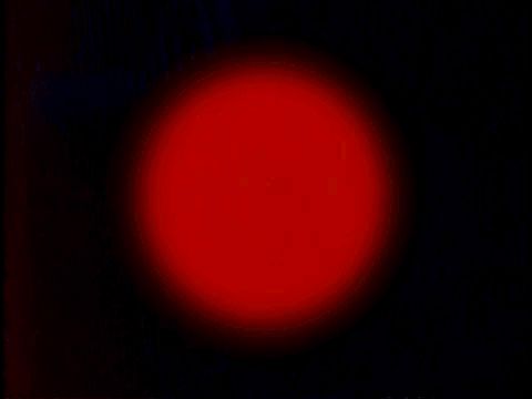 A digital image of a glowing red circle against a black background
